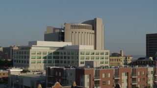 DX0001_001249 - 5.7K aerial stock footage descend by federal courthouse behind government building at sunrise, Downtown Kansas City, Missouri