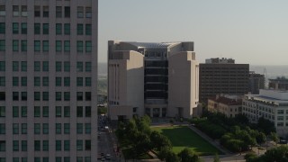 5.7K aerial stock footage flyby the federal courthouse for closer view of skyscraper at sunrise, Downtown Kansas City, Missouri Aerial Stock Footage | DX0001_001258