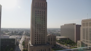 DX0001_001267 - 5.7K aerial stock footage orbit city hall and tilt to the front steps at sunrise, Downtown Kansas City, Missouri