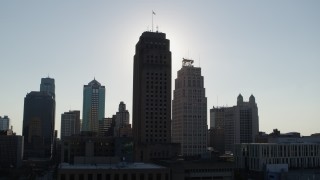 5.7K aerial stock footage of the sun behind city hall and skyscraper in Downtown Kansas City, Missouri Aerial Stock Footage | DX0001_001330