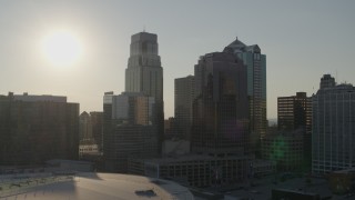 5.7K aerial stock footage of the setting sun behind tall skyscrapers in Downtown Kansas City, Missouri Aerial Stock Footage | DX0001_001345