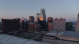 5.7K aerial stock footage flyby skyscrapers near hotel at sunset and hover for static view in Downtown Kansas City, Missouri Aerial Stock Footage | DX0001_001369