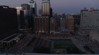 5.7K aerial stock footage ascend from near park for a view of city skyscrapers at twilight in Downtown Kansas City, Missouri Aerial Stock Footage | DX0001_001383