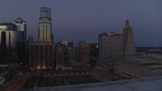 5.7K aerial stock footage a view of a downtown hotel between skyscrapers at twilight in Downtown Kansas City, Missouri Aerial Stock Footage | DX0001_001392