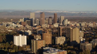 5.7K aerial stock footage of skyscrapers in Downtown Denver, Colorado at sunrise, seen while passing apartment buildings Aerial Stock Footage | DX0001_001413