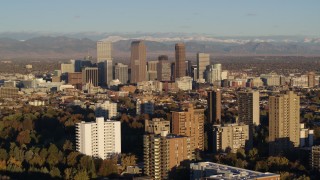 5.7K aerial stock footage of tall skyscrapers in Downtown Denver, Colorado at sunrise, seen while flying by apartment buildings Aerial Stock Footage | DX0001_001415