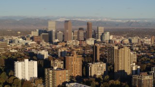 5.7K aerial stock footage of tall skyscrapers in Downtown Denver, Colorado at sunrise, seen while flying past apartment buildings Aerial Stock Footage | DX0001_001416