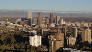 5.7K aerial stock footage of tall skyscrapers in Downtown Denver, Colorado at sunrise, seen while ascending near apartment buildings Aerial Stock Footage | DX0001_001418