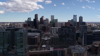 DX0001_001496 - 5.7K aerial stock footage of the city's skyline seen while flying by office buildings in Downtown Denver, Colorado