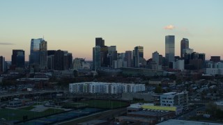 5.7K aerial stock footage of a reverse view of the city's skyline at sunset before descent, Downtown Denver, Colorado Aerial Stock Footage | DX0001_001568