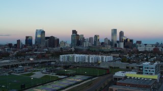 5.7K aerial stock footage of flying by the city's downtown skyline at sunset, Downtown Denver, Colorado Aerial Stock Footage | DX0001_001572