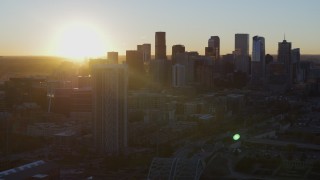 DX0001_001613 - 5.7K aerial stock footage of the city skyline at sunrise, seen from residential skyscraper in Downtown Denver, Colorado