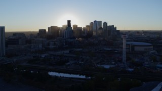 5.7K aerial stock footage flyby bright sun and city skyline, seen from theme park and arena at sunrise in Downtown Denver, Colorado Aerial Stock Footage | DX0001_001622