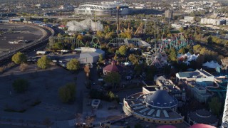 DX0001_001634 - 5.7K aerial stock footage fly over rides at Elitch Gardens at sunrise in Downtown Denver, Colorado