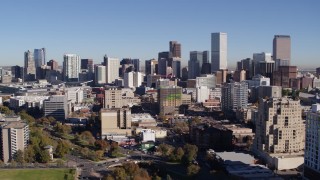 5.7K aerial stock footage of the city's skyline, while passing office and apartment buildings in foreground, Downtown Denver, Colorado Aerial Stock Footage | DX0001_001669