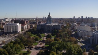 5.7K aerial stock footage of the Colorado State Capitol building, seen while flying over park, Downtown Denver, Colorado Aerial Stock Footage | DX0001_001690