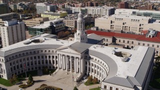 DX0001_001696 - 5.7K aerial stock footage descend while passing the Denver City Council building, Downtown Denver, Colorado