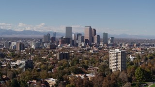 5.7K aerial stock footage of the city's skyline with mountains in the background, seen during descent, Downtown Denver, Colorado Aerial Stock Footage | DX0001_001724