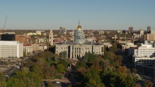 5.7K aerial stock footage of flying by Colorado State Capitol and tree-lined park in Downtown Denver, Colorado Aerial Stock Footage | DX0001_001783