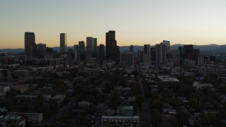 5.7K aerial stock footage fly away from the city skyline at sunset, descend toward trees in Downtown Denver, Colorado Aerial Stock Footage | DX0001_001844