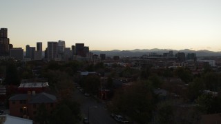 5.7K aerial stock footage of pan across apartment buildings to reveal the city's skyline at sunset, Downtown Denver, Colorado Aerial Stock Footage | DX0001_001848