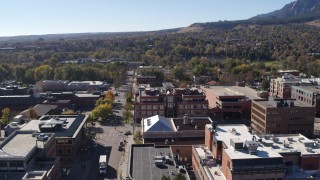 DX0001_001905 - 5.7K aerial stock footage flying by brick office building at quiet intersection in Boulder, Colorado