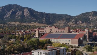 DX0001_001946 - 5.7K aerial stock footage descend while passing campus buildings at the University of Colorado Boulder