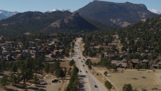 DX0001_001975 - 5.7K aerial stock footage of cars on a road through the town of Estes Park, Colorado