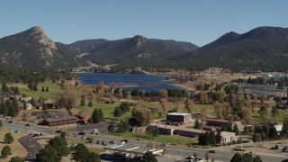 5.7K aerial stock footage ascend for wider view of Lake Estes, golf course and green mountains in Estes Park, Colorado Aerial Stock Footage | DX0001_001983