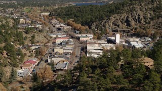 DX0001_001994 - 5.7K aerial stock footage fly over trees toward shops lining road through Estes Park, Colorado