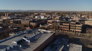 DX0001_002019 - 5.7K aerial stock footage fly away from a row of brick office buildings and shops in Fort Collins, Colorado