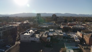 DX0001_002024 - 5.7K aerial stock footage flying by shops with view of taller office buildings in Fort Collins, Colorado