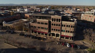 DX0001_002031 - 5.7K aerial stock footage of passing a brick office building in Fort Collins, Colorado