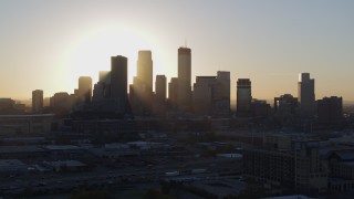 5.7K aerial stock footage flying by the rising sun behind the city skyline in Downtown Minneapolis, Minnesota Aerial Stock Footage | DX0001_002081