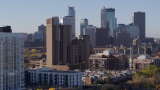 5.7K aerial stock footage descend near condo complex with view of city's skyline at sunrise in Downtown Minneapolis, Minnesota Aerial Stock Footage | DX0001_002111