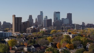 DX0001_002130 - 5.7K aerial stock footage the downtown skyline seen from residential neighborhood at sunrise in Downtown Minneapolis, Minnesota