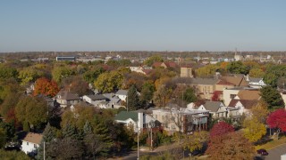 5.7K aerial stock footage descend behind trees in suburban neighborhood at sunrise in Minneapolis, Minnesota Aerial Stock Footage | DX0001_002132