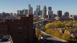 DX0001_002141 - 5.7K aerial stock footage fly over building to approach skyline and a bridge spanning the river in Downtown Minneapolis, Minnesota