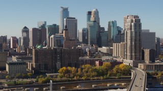 DX0001_002152 - 5.7K aerial stock footage flyby the skyline on the other side of the Mississippi River during ascent, Downtown Minneapolis, Minnesota