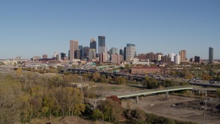 5.7K aerial stock footage a view of the city skyline while flying away from freeway, Downtown Minneapolis, Minnesota Aerial Stock Footage | DX0001_002171