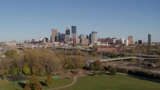 5.7K aerial stock footage a wide view of the city skyline while flying over a park, Downtown Minneapolis, Minnesota Aerial Stock Footage | DX0001_002172