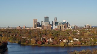 5.7K aerial stock footage of the city's skyline seen while flying by lakefront homes, Downtown Minneapolis, Minnesota Aerial Stock Footage | DX0001_002190