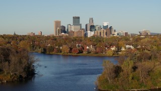 5.7K aerial stock footage ascend from Lake of the Isles for a view of the downtown skyline, Downtown Minneapolis, Minnesota Aerial Stock Footage | DX0001_002198