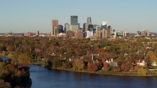 5.7K aerial stock footage of the downtown skyline seen from waterfront homes by Lake of the Isles, Downtown Minneapolis, Minnesota Aerial Stock Footage | DX0001_002202