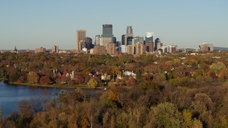 5.7K aerial stock footage ascend from Lake of the Isles for wide view of the skyline of Downtown Minneapolis, Minnesota Aerial Stock Footage | DX0001_002207