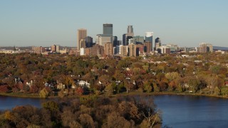 5.7K aerial stock footage flyby the skyline of Downtown Minneapolis, Minnesota before descending toward lake Aerial Stock Footage | DX0001_002208