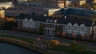 5.7K aerial stock footage of flying away from an apartment building at sunset in Minneapolis, Minnesota Aerial Stock Footage | DX0001_002211