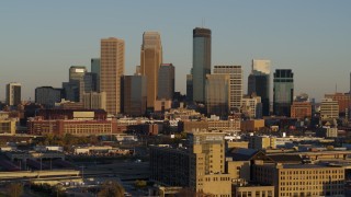 5.7K aerial stock footage of a reverse view of the city's downtown skyline at sunset in Downtown Minneapolis, Minnesota Aerial Stock Footage | DX0001_002215