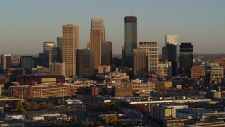 5.7K aerial stock footage of passing by the city's downtown skyline at sunset in Downtown Minneapolis, Minnesota Aerial Stock Footage | DX0001_002217