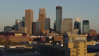 5.7K aerial stock footage ascend while flying by the city's downtown skyline at sunset in Downtown Minneapolis, Minnesota Aerial Stock Footage | DX0001_002223